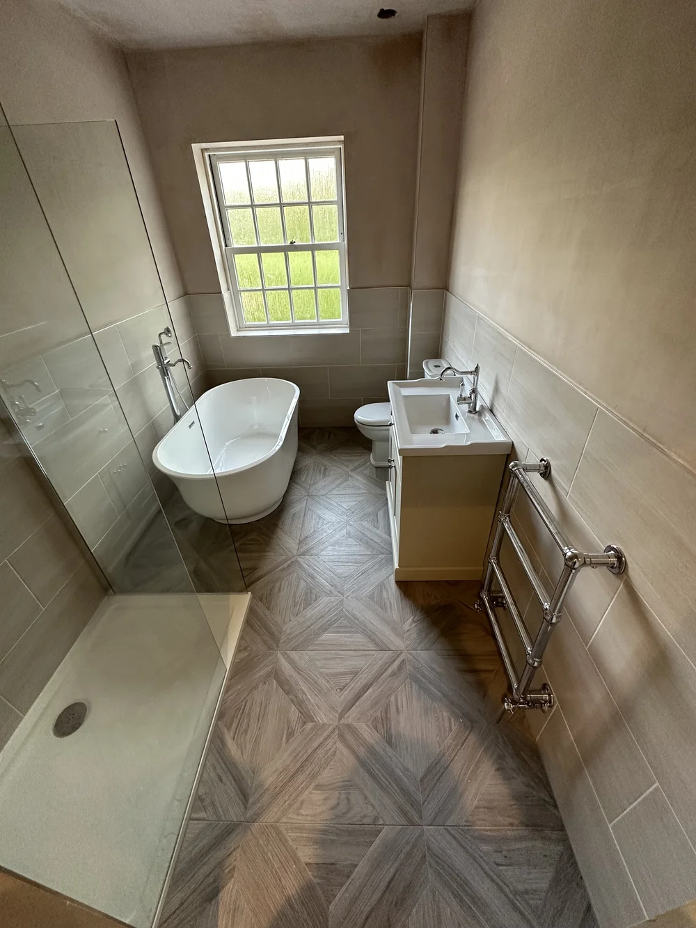 Traditional bathroom with freestanding slipper bath, cream shaker vanity and parquet floor — bathroom renovation in Sunningdale